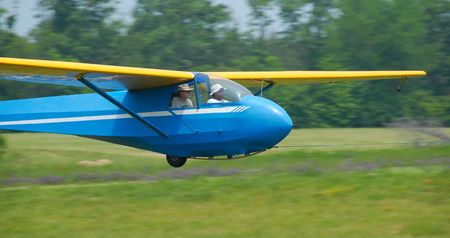 glider landing on grass landing runwayの写真素材