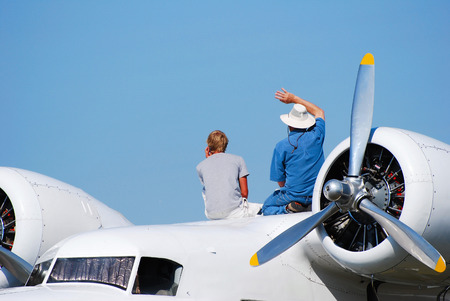 large vintage airplane with crew watching an airshowの写真素材