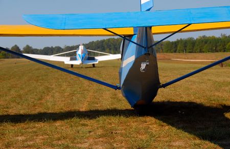 sailplane taking off behind towplane on grass runwayの写真素材