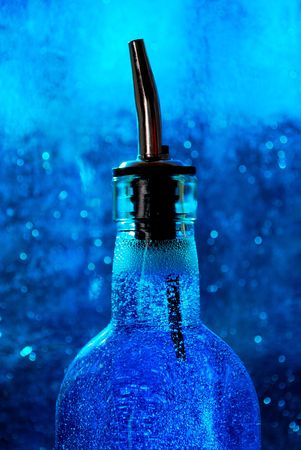 bottle of liquid against blue backgroundの写真素材