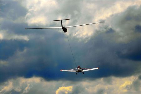 towplane pulling a sailplane in a dramatic skyの写真素材