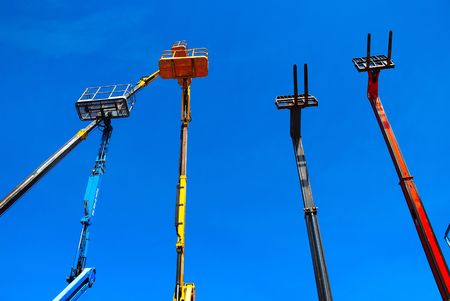 mobile lift trucks against a blue skyの写真素材