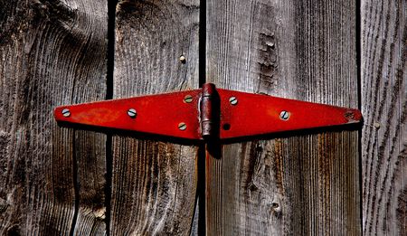 rusted hinge on weathered wood barn