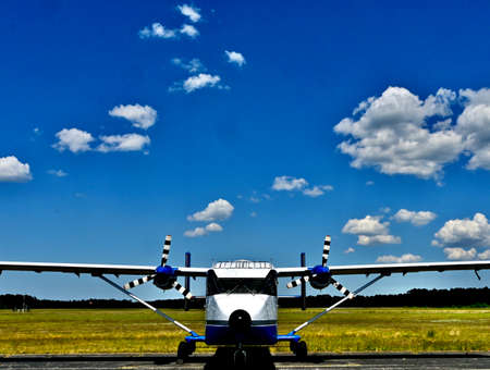 utility aircraft parked with a bright sky
