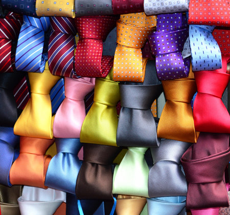 Colorful neckties in a shop window, closeup of photo