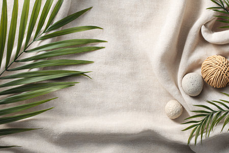 Composition with green palm leaves, spa stones and towel on light backgroundの写真素材