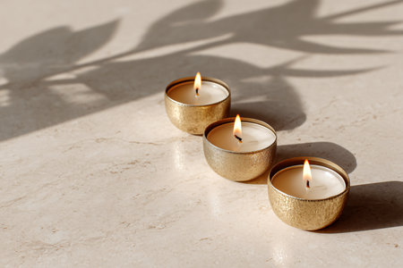 Burning candles on white marble table, closeup. Space for textの素材