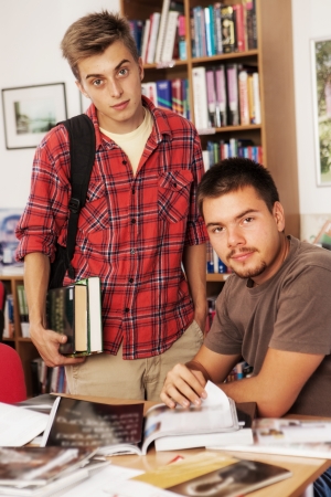 Two students working and studying in a college libraryの写真素材