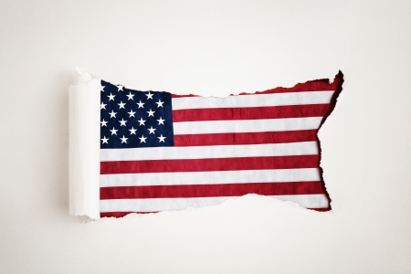 Torn paper reveals the American flagの写真素材