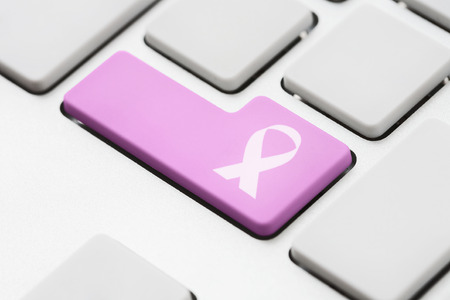 Cancer ribbon symbol on computer key