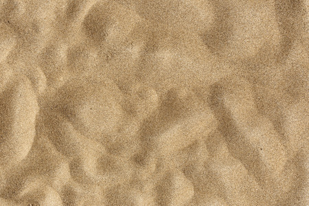 Closeup of sand pattern of a beach in the summerの写真素材