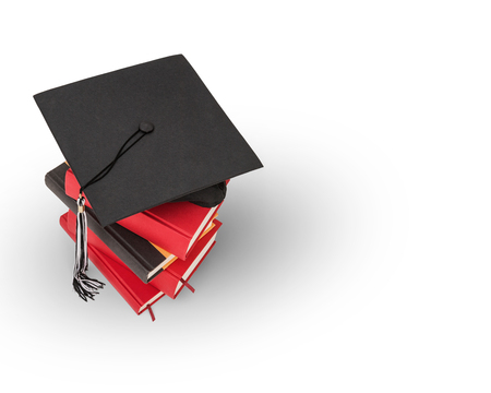 Graduation cap on top of a stack of booksの写真素材