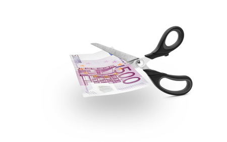 Scissors cutting money -Scissors to cut a 500 euro bill on white backgroundの写真素材
