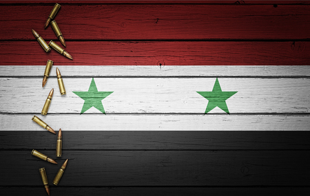 Syria flag with bullets on wooden background, Conceptual image for war, violence, conflictsの写真素材