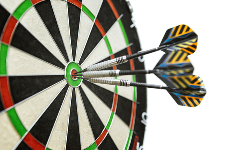 Dart in bulls eye of dartboard with shallow depth of field concept for hitting targetの写真素材
