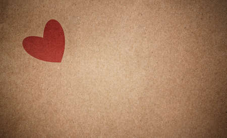 Brown recycled paper background with red heartの写真素材