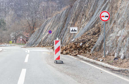 Rocks blocking the road due to a slope slideの写真素材