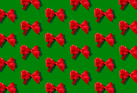 Pattern of red bow on green backgroundの写真素材