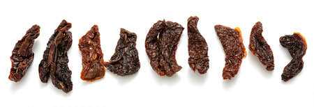 Tasty sun dried tomatoes on white background, top view