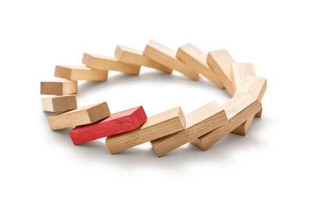 Stop the destructive processes -The red wooden block triggered a domino effect, Circle made of toppled wooden blocks on a white background, including clipping pathの写真素材