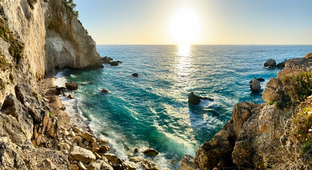 Beautiful beach and water bay in the greek spectacular coastline. Sunset gorgeous sky over blue water unique rocky cliffs. Greece summer top travel destination Lefkada islandの写真素材