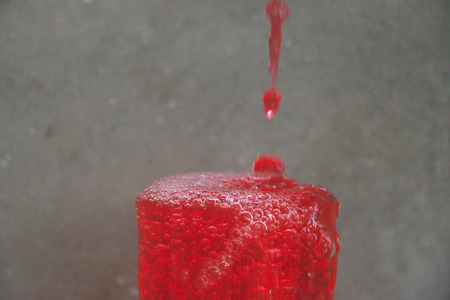 Action of drop water and Water glass on the wood table in front of the cement wall backgroundの写真素材