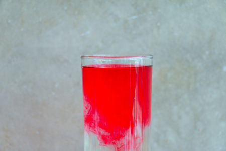 Action of drop water and Water glass on the wood table in front of the cement wall backgroundの写真素材
