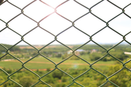Steel net with lighting sun backgroundの写真素材