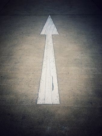 White arrow symbol on the roadの写真素材