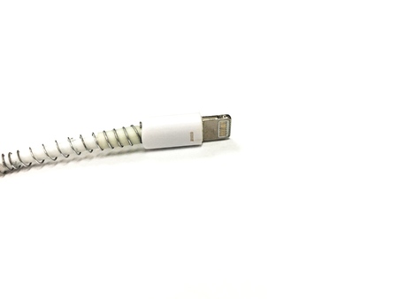 Smart phone wiring charger on the white paper background.の写真素材