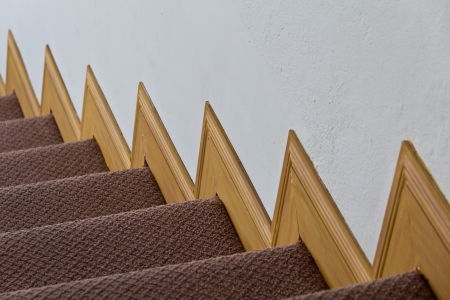 Red carpet on stairs and wood trim on the walls の写真素材