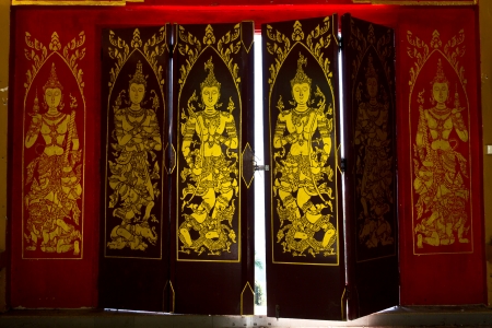 Decorated wooden doors at the temple in Thailand.の写真素材