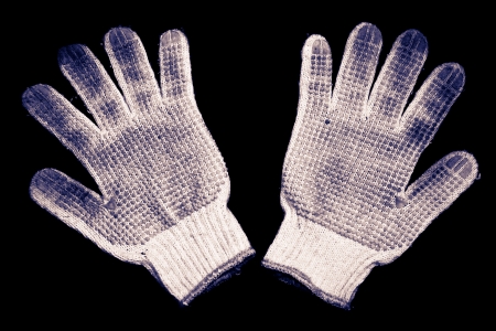 Old gloves on a black background の写真素材