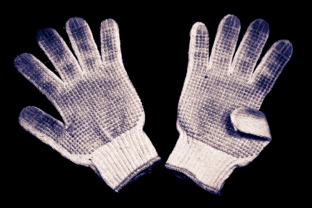 Old gloves on a black background の写真素材