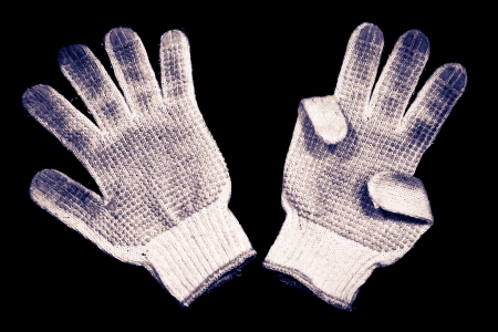 Old gloves on a black background の写真素材