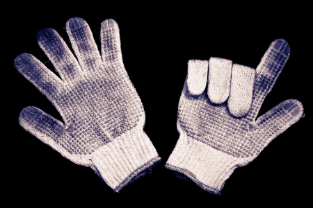Old gloves on a black background の写真素材
