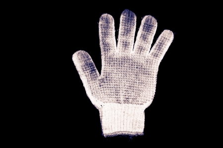 Old gloves on a black background の写真素材