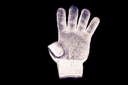 Old gloves on a black background の写真素材