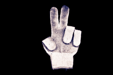 Old gloves on a black background の写真素材