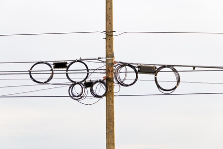 Electric power lines on poles の写真素材