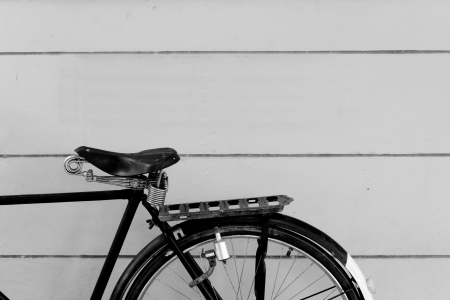 Some of the bikes parked along the wall.Black and white vintage bicycle.の写真素材