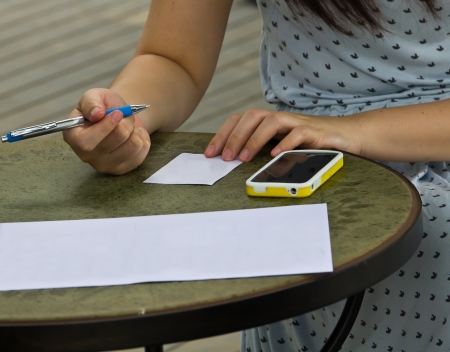 Woman sitting on the outdoor tables.の写真素材