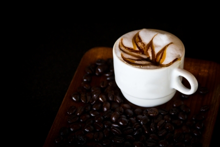 Coffee in white cup with coffee surrounded inquire.の写真素材