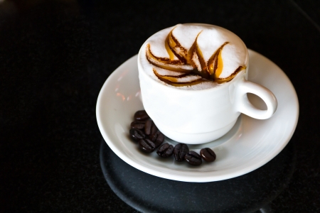Coffee in white cup with coffee surrounded inquire.の写真素材