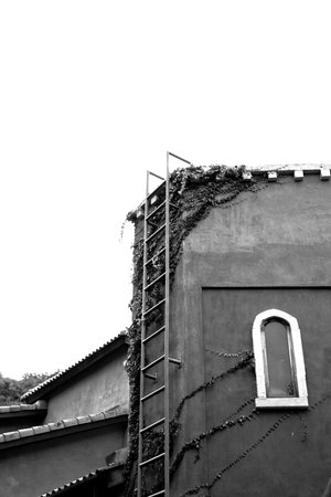 Stairs made of steel attached to the wall of the old house のeditorial素材