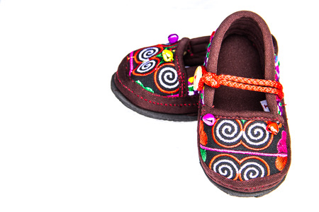 Craft baby shoes on a white background の写真素材