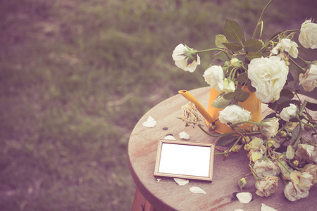 Wooden photo frames  and vase roses wither.の写真素材