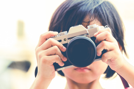 young girl taking photos by mirrorless digital camera.の写真素材