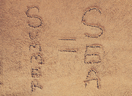 written on sand.sea and sand background.Concepcion tour over the summer.の写真素材