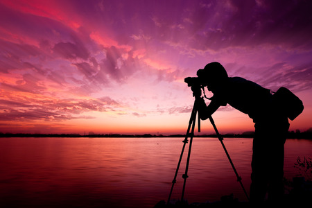 Silhouette of photographers on the edge of the lagoon and beautiful sky.